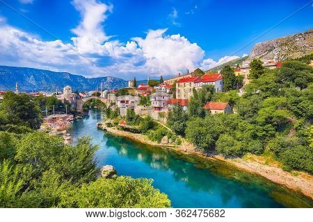 Fantastic Skyline Of Mostar With The Mostar Bridge, Houses And Minarets, During Sunny Day. Location: