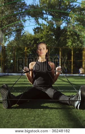 Sport lány gyakorlat az utcán espander