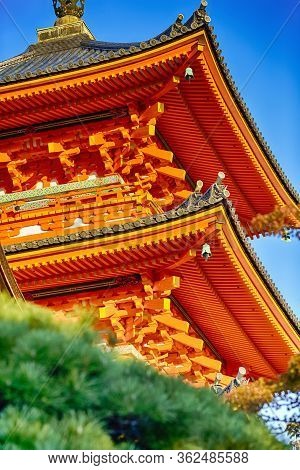Japanese Religiuos Heritage. Closeup Of Wings Of Kiyomizu-dera Temple At Daytime. With Trees In Fore