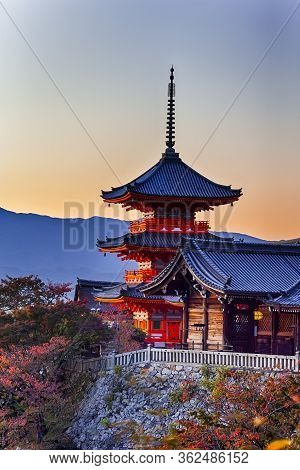 Japanese Heritage. Vivid Sunset Over Kiyomizu-dera Temple Pagoda With Traditional Red Maple Trees In