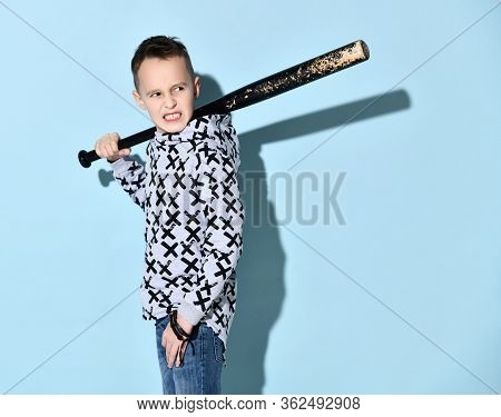 Teenage Boy In Hoodie, Jeans And Black Bracelet. He Is Grinning, Holding Black Shabby Baseball Bat O