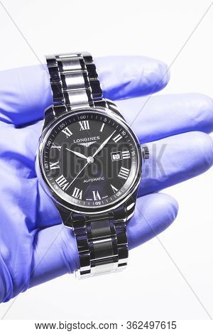 Saint-imier, Switzerland 31.03.2020 - Closeup Image Of Longines Watch In The Male Palm In A Blue Glo