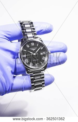 Saint-imier, Switzerland 31.03.2020 - Closeup Image Of Longines Watch In The Male Palm In A Blue Glo