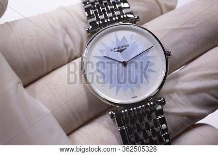 Saint-imier, Switzerland 31.03.2020 - Closeup Image Of Longines Watch In The Male Palm In A White Gl