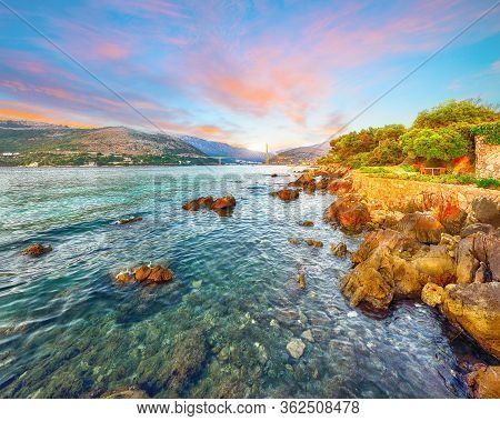 Panorama Of Impressive Franjo Tudjman Bridge At Sunset And Rocky Shore Of Dubrovnik. Location:  Dubr