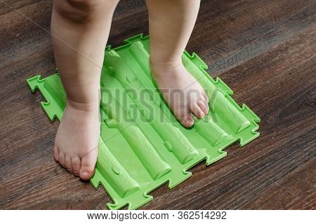 Child On Massage Mat Doing Exercises For Flatfoot Prevention
