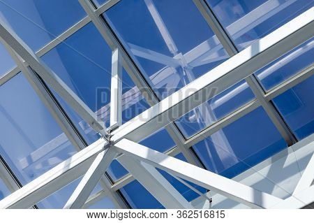 Steel Frame Of The Glazed Roof Of A Warehouse, Shopping Or Office Center. The Ceilings Are Made Of M