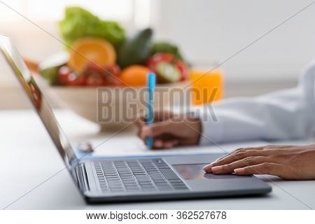 Online Consultation From Dietologist During Quarantine. Cropped Of Black Woman Nutritionist Working 