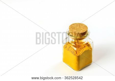 Colorful Spice Turmeric In Glass Bottle On The White Background Isolated. Anti-inflamatory Remedy, I