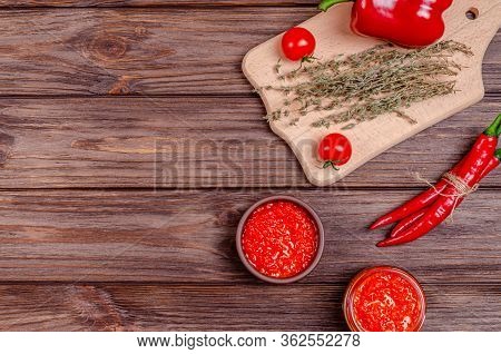Ajvar Or Pindjur Red Vegetable Spread Or Pepper Paprika And Tomato Mousse In A Clay Bowl And In A Gl