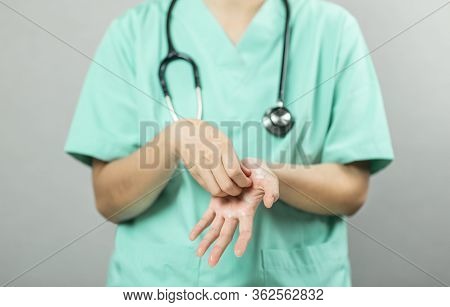 Nurse Or Doctor In Green Uniform With Stethoscope Is Demonstrating Washing And Cleaning Hands And Wr