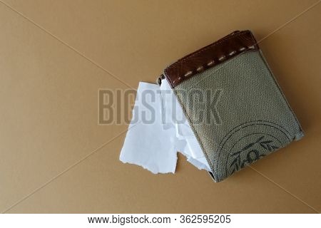 Empty Wallet With Pieces Of Paper Instead Of Money On A Light Monophonic Background, Top View. Bankr