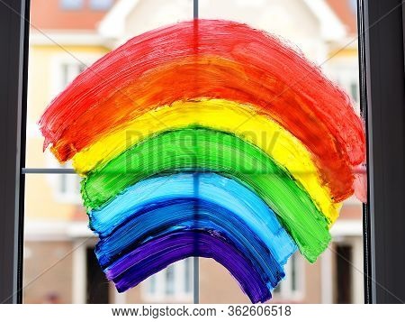 Drawing Of Rainbow On Home Window While Coronavirus Quarantine. Sign Rainbow Is Symbol Of Hope, Mean