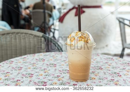 Ice Coffee With Cream On Table. Caramel Frappe Coffee In The Coffee Shop. Iced Blended Frappucino. F
