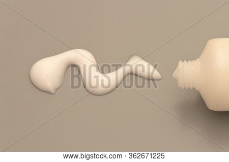 Drop Of Hand Cream, Cosmetik Body Lotion Moisturizer On Gray Background.