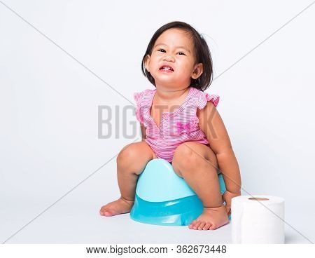 Asian Little Cute Baby Child Girl Education Training To Sitting On Blue Chamber Pot Or Potty With To