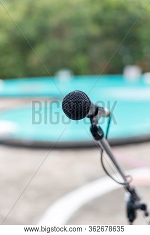 Microphone Outdoor Near Swimming Pools Soft And Blur Style For Background. Microphone Over The Abstr
