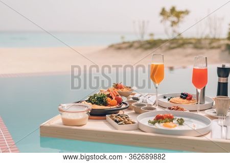 Breakfast In Swimming Pool, Floating Breakfast In Tropical Resort. Table Relaxing In Calm Pool Water