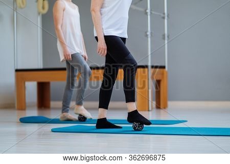 Physiotherapist Teaching Self Massage By Dint Of Orange Balls Female Patient With Injured Shoulder B