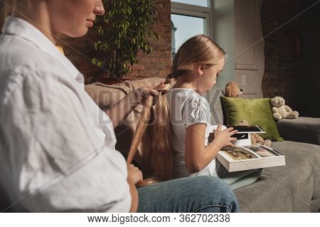 Hairdo, Hairstyle. Mother And Daughter During Self-insulation At Home While Quarantined, Family Time
