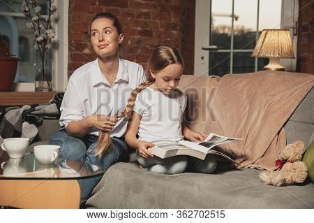 Hairdo, Hairstyle. Mother And Daughter During Self-insulation At Home While Quarantined, Family Time