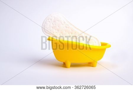 White Feminine Sanitary Pad In An Impromptu Yellow Bath