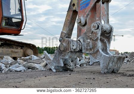 Excavator With Hydraulic Shears For Cutting And Crumbles Demolition Concrete And Asphalt At Construc