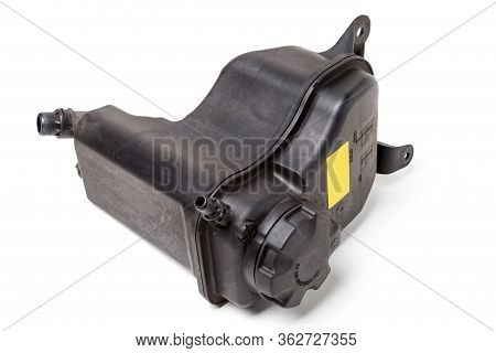 Coolant Expansion Tank In Black On A White Isolated Background With A Yellow Nameplate. The Unit Of 