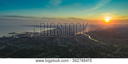 Industrial City In Summer. On The Horizon, A Metallurgical Plant Near The Sea