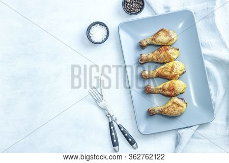 Grilled Chicken Legs On Plate On Grey Background. Top View.