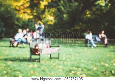 Blurred, Backgraund, Walking, People, Park, City, Green. Blurred Background Of A Park In The City Wi