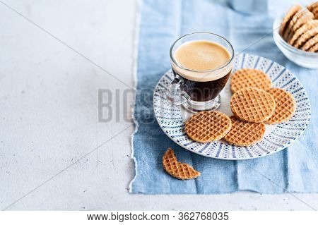 Glass Cup Of Coffee With Dutch Caramel Mini Stroopwafels, Syrupwaffles Cookies On Light Gray Backgro
