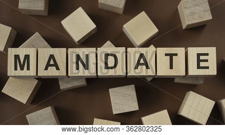 Wooden Cubes With Word Mandate On Blue Table. Cubes With Blue Letters.