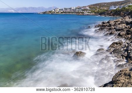 Waves Hitting The Rocks During Hot Summer Day In Greece