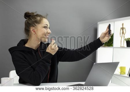 Beautiful Smiling Girl In Casual Weal, Hear In Bun Talks By Webcam On Phone With Headphones, Happy Y