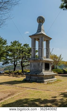 Jinan, South Korea; April 21, 2020: Tall Concrete Monument In Plaza Of Public Park Under Clear Blue 