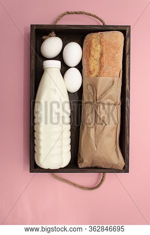 Donation Food. Corn, Buckwheat In Jar, Bananas, Milk, Bread, Bananas On Pink Background.