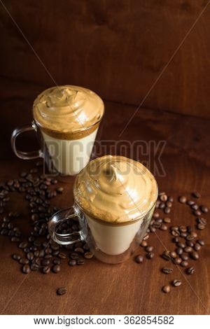 Cold Dalgon Coffee In Clear Glasses On A Dark Wooden Background. Foam From Sugar And Instant Coffee