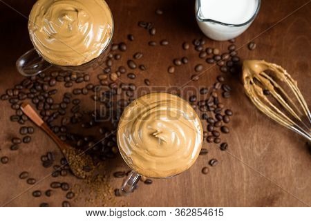 Cold Dalgon Coffee In Clear Glasses On A Dark Wooden Background. Foam From Sugar And Instant Coffee