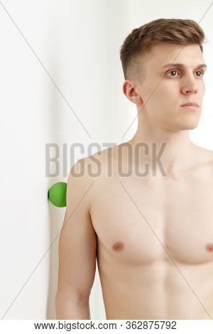 Handsome Man Shows Exercises Using The Ball With Spikes
