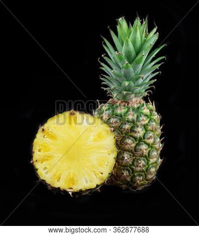 Fresh Pineapple Isolated On Black Background. Juicy Pineapple. Fruits Photo Collection. One And Half