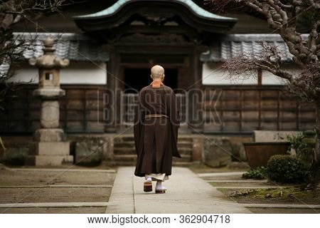 A Monk In Court Yard Of A Monastery In Kamakura, Japan.