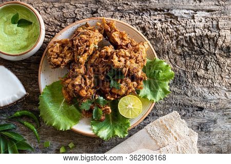 Indian Cuisine. Pakora Traditional Indian Deep-fried Snack. Pakoras On Black Plate With Coconut Chut