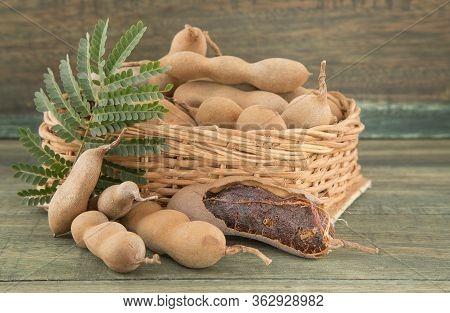 Tamarind Tropical Fruit - Tamarindus Indica. Wood Background