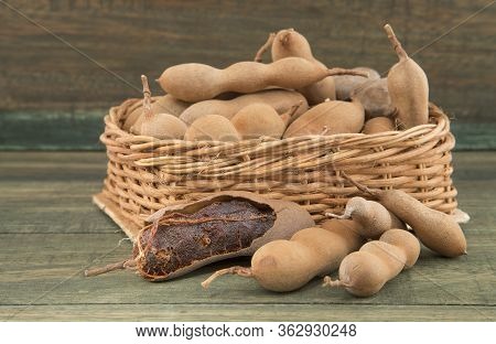 Tamarind Tropical Fruit - Tamarindus Indica. Wood Background