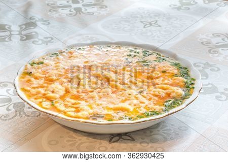 View Of Tomato Soup With Lane Kluski Noodles.