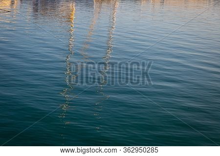 Reflections Of Boats In The Harbor On Sea Water