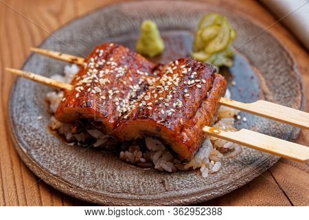 Fried unagi eel with barbecue sauce and rice close-up