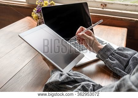 Business Woman Working At Home With Her Laptop And Tablat.