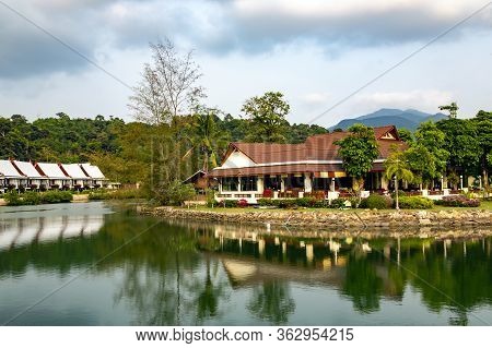 Thailand, Koh Chang, May, 2014 - Summer Wooden Bungalows Ashore Of The Pond Surrounded By A Beautifu